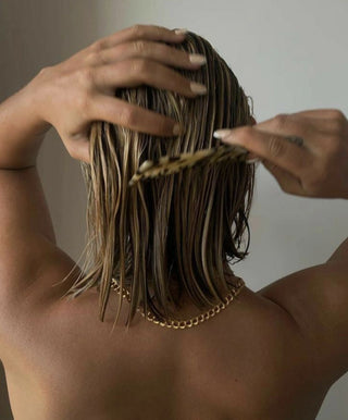 Model combing through short, wet hair 
