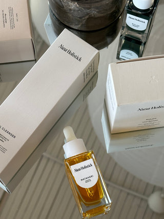 Nusa Holistick products arranged on top if a mirrored table.