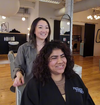 Private Studio hairstylist, Cindy Li performing a consultation on a client at her station