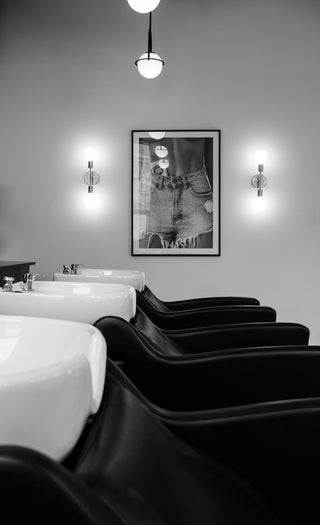 A black and white image of Private Studio's hair washing station.