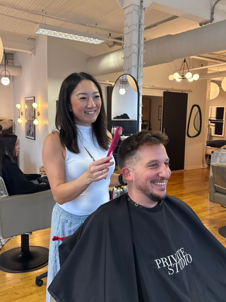 Private studio hairstylist, Cindy Li  cutting a men's haircut in the salon