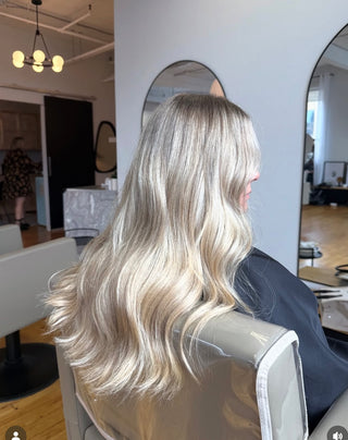 A Private Studio client showing off her fresh haircut and dimensional, lived-in blonde hair colour.