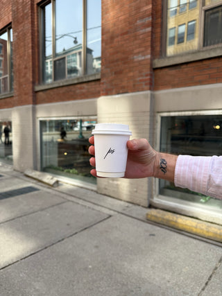 a Private Studio coffee cup outside the salon in Toronto, Ontario. 