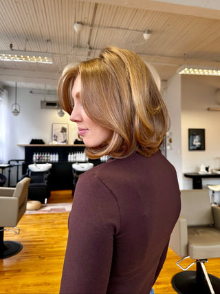 a private Studio client with a Layered "Old-Money" Bob and bouncy blowout by Kristen Patterson standing in the salon