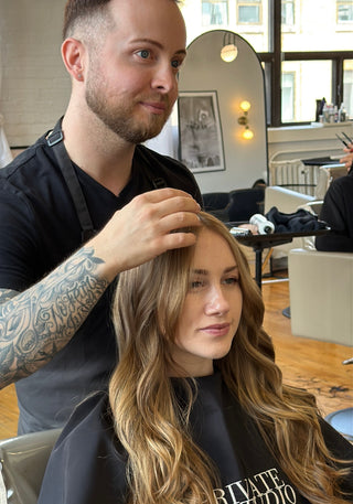 a Private Studio hairstylist, Richie Araish working on a client in the salon chair
