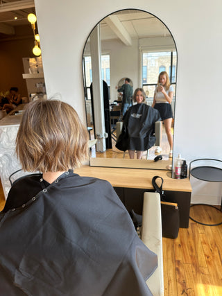 Kristen Patterson photographing a client's fresh bob haircut at Private Studio in Toronto.

