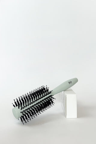 R+Co vegan boar bristle hair brush with wooden handle and natural bristles, ideal for smoothing and adding shine to hair.