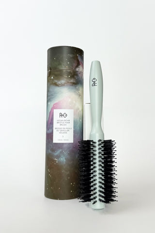 R+Co vegan boar bristle hair brush with wooden handle, showcasing natural bristles for gentle hair styling and detangling.