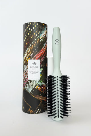 R+Co #4 vegan boar bristle hair brush with natural wooden handle and densely packed bristles for gentle styling and detangling.
