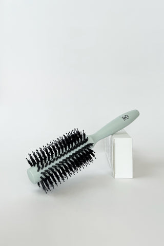 R+Co #3 Vegan Boar Bristle Hair Brush with wooden handle and natural bristles for gentle hair styling and detangling.