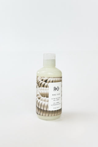 R+Co Ring Tone Ultra Defining Curl Gel Creme in a jar, showcasing its creamy texture for defining curls and waves.