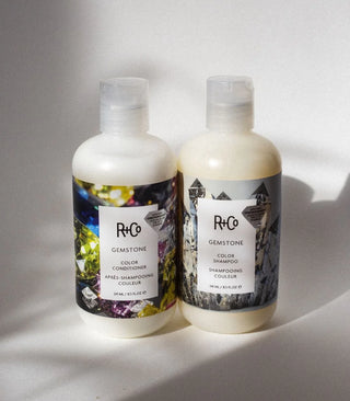 R+Co gemstone color shampoo bottle with vibrant label, showcasing nourishing shampoo for colorful hair care in a sleek design.